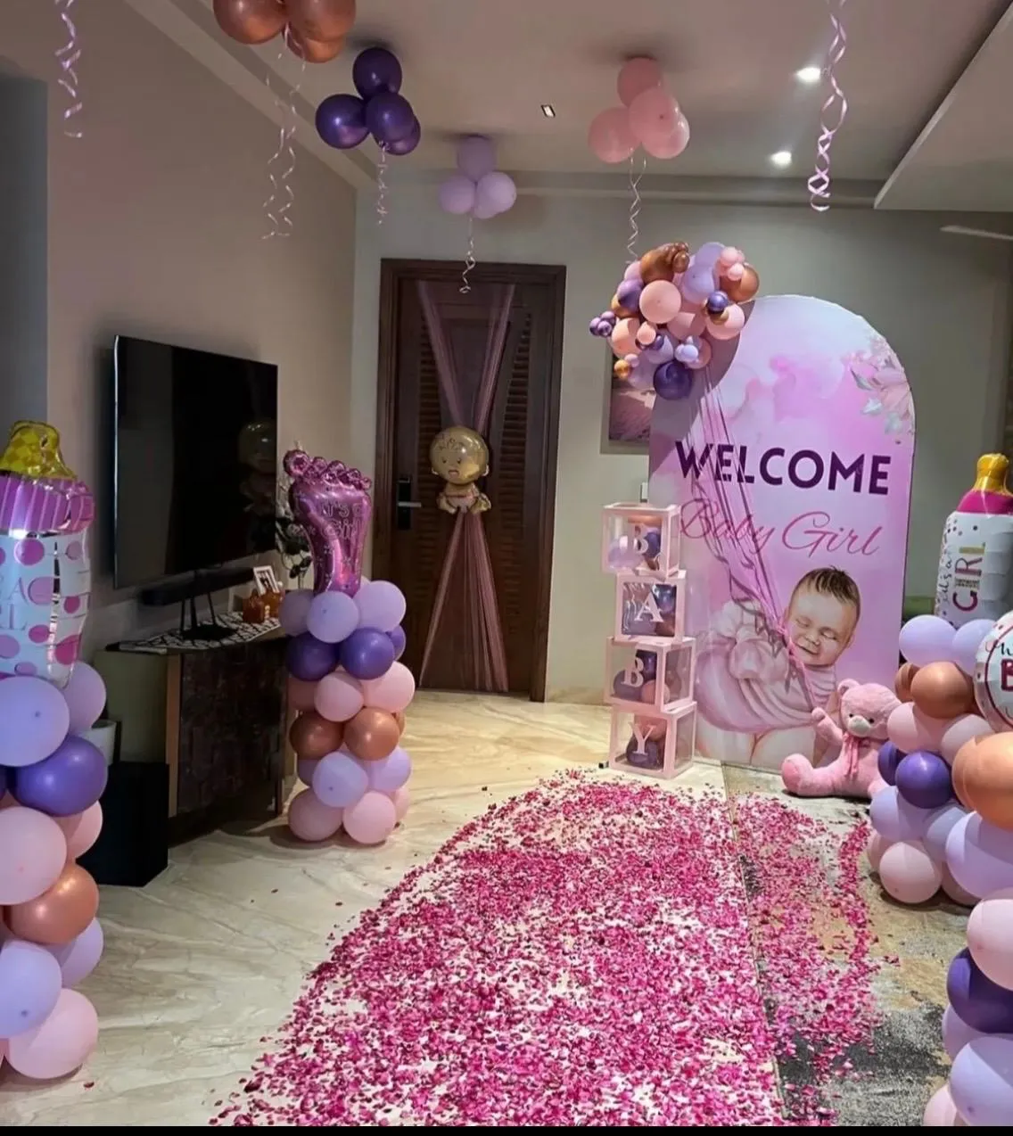 Welcome Home Theme with balloons, 4 Foil Balloon Pillars, Rose Petal Walkway , cake table and lights.