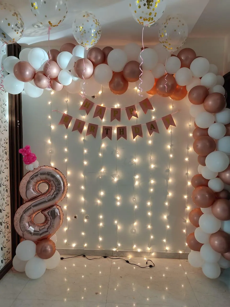 Pastel balloon wall decoration with warm lights