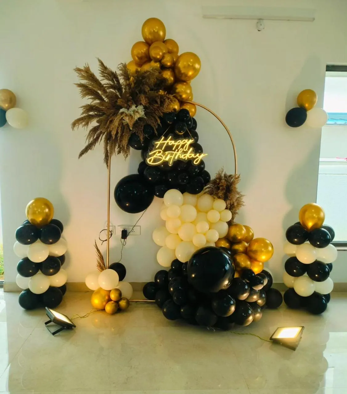 Black, white and gold balloon arch for a milestone birthday